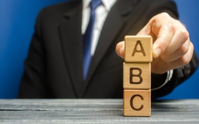 businessman-arranging-wooden-blocks-with-abc-lette-2026-01-08-23-02-34-utc-800w