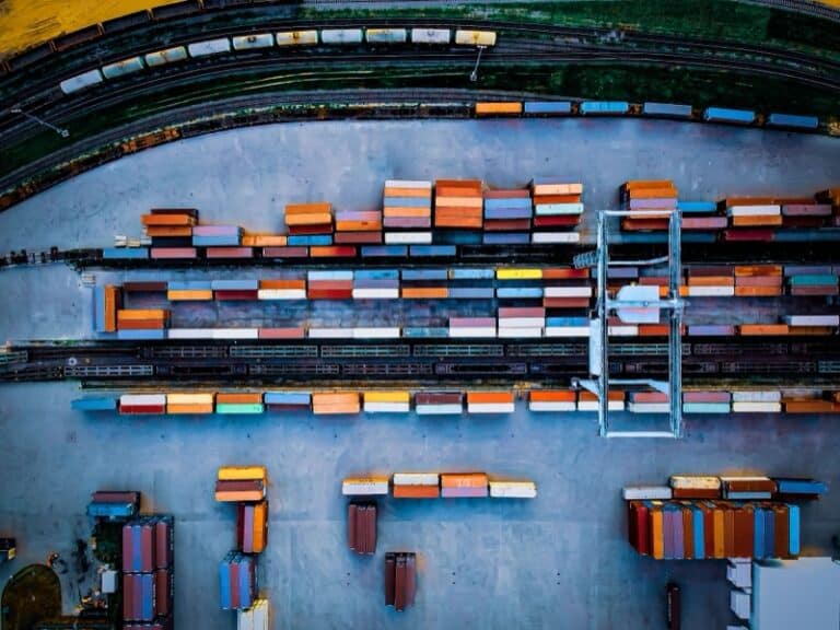 Top view of colorful freight trains on the railway station